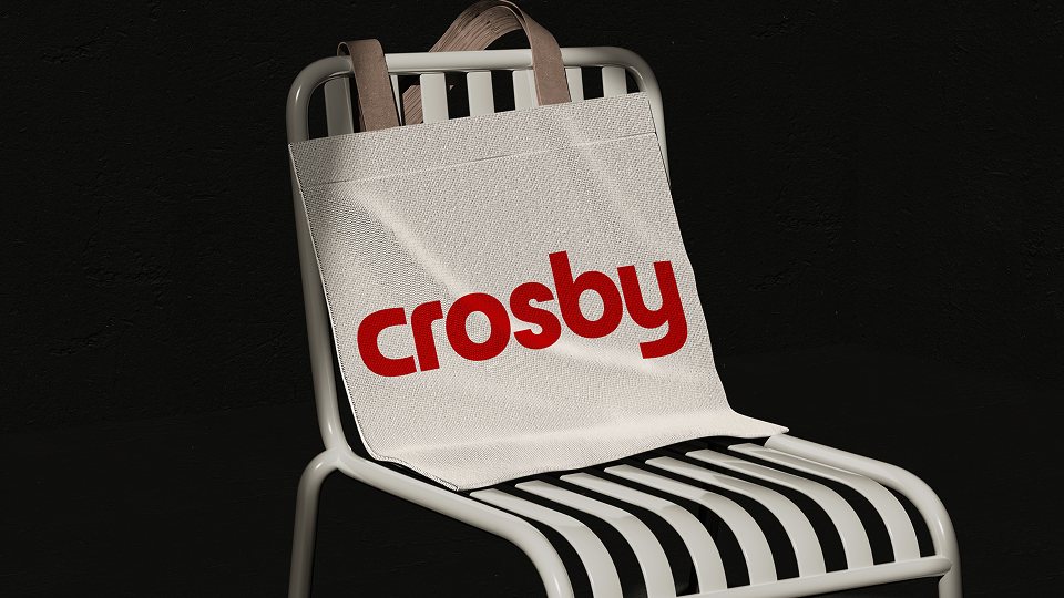 Crosby brand application: a canvas tote bag with the red Crosby wordmark on a white metal chair
